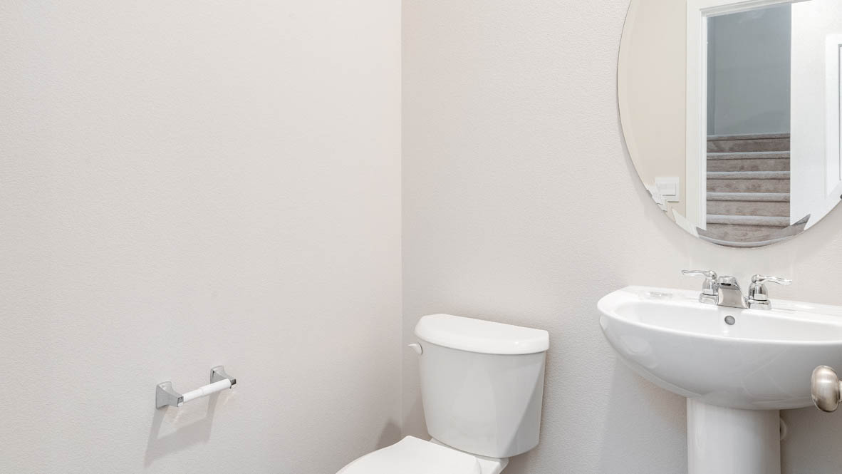 Marcola Meadows powder room with oval mirror, toilet, single vanity, and white walls
