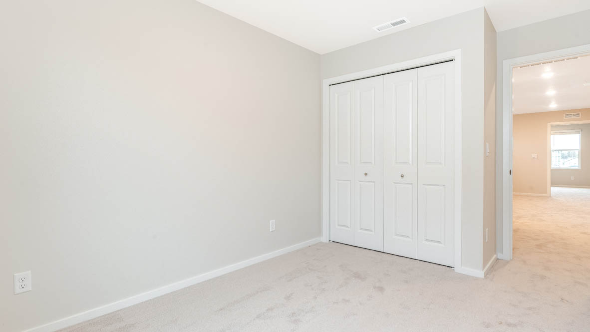 Marcola Meadows bedroom with window, carpet, closet, view of hallway, and walls