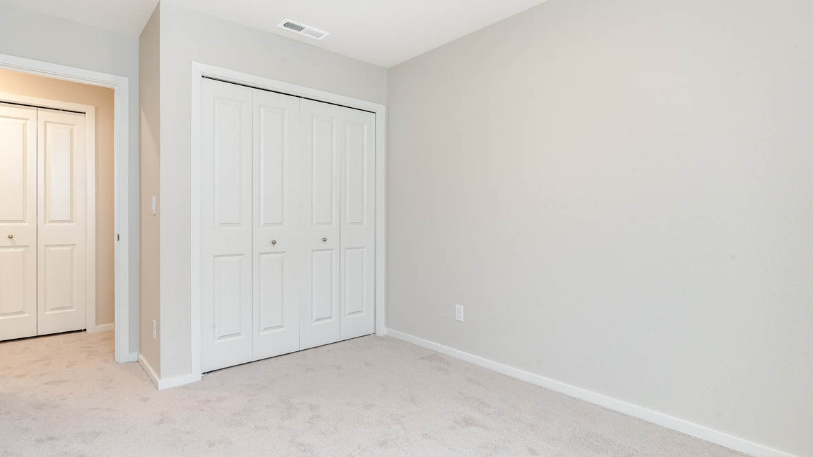 Marcola Meadows bedroom with window, carpet, closet, view of hallway, and walls