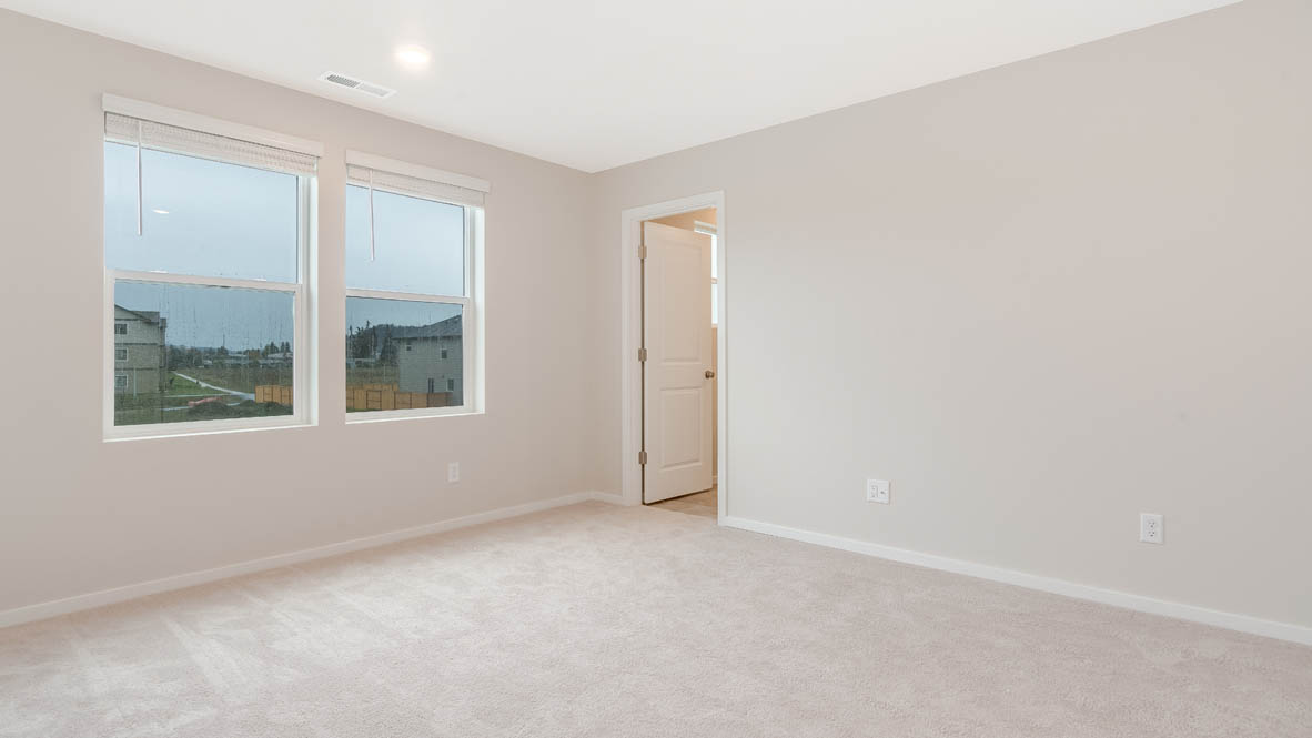 Marcola Meadows primary bedroom, carpet, windows, view of en suite bathroom, and white walls