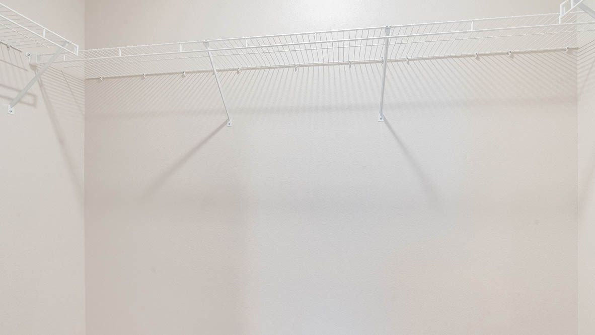 Marcola Meadows walk-in closet with white wire shelving and white walls