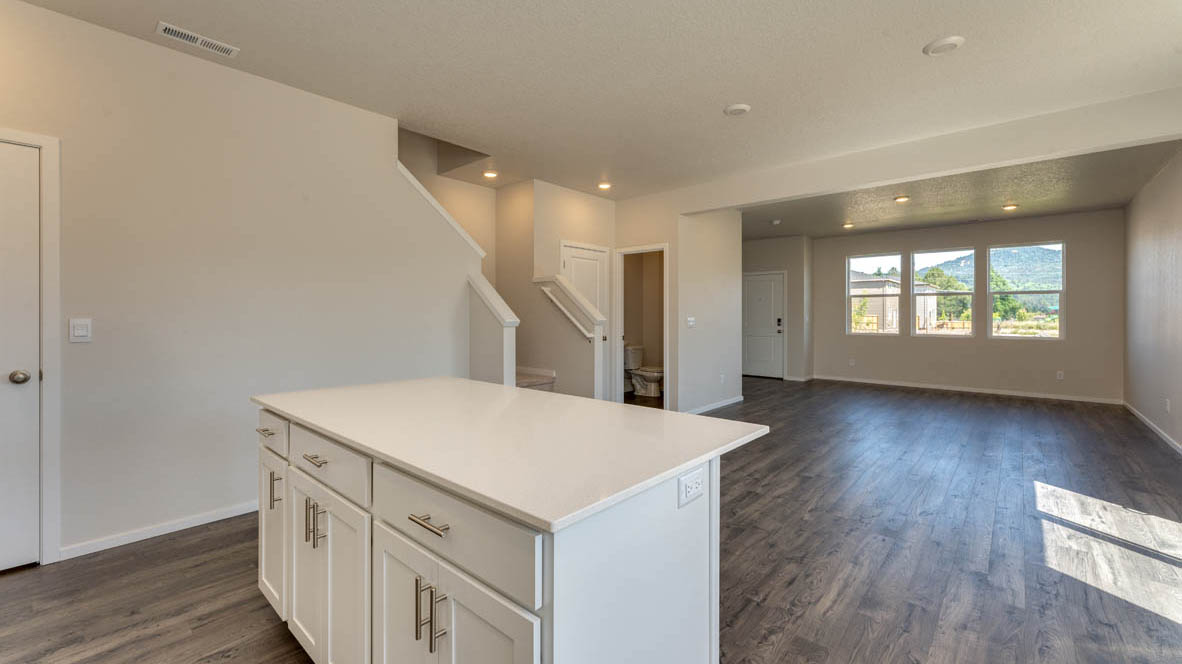 Marcola Meadows Kitchen with white quartz countertops, white cabinets, an island and stainless steel appliances