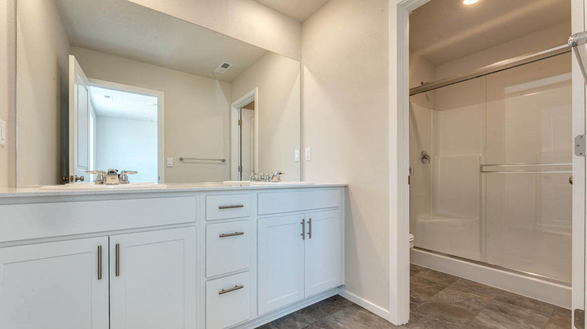 Marcola Meadows primary bathroom with two sink vanity and walk in closet