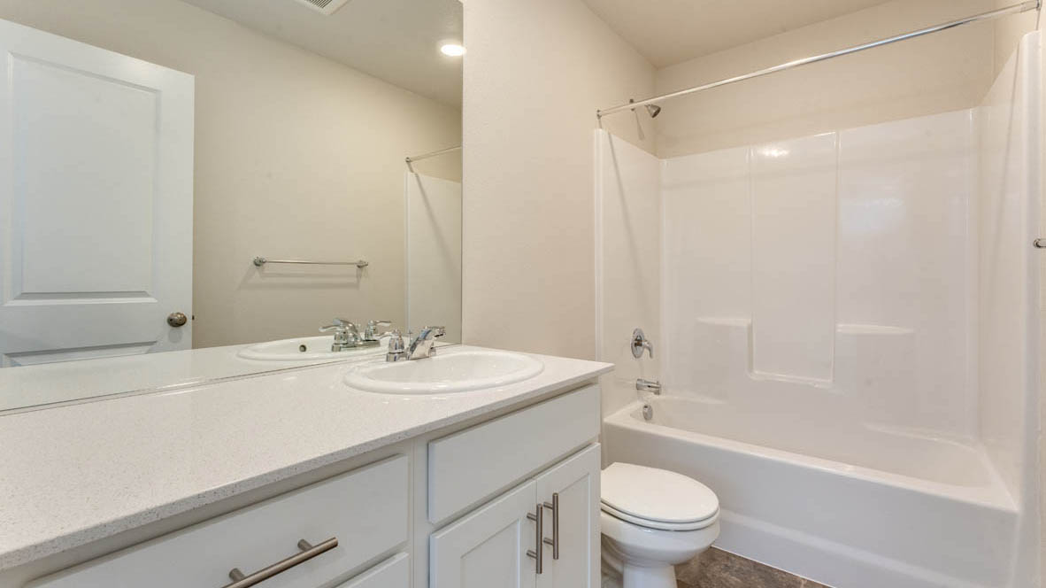 Marcola Meadows Bathroom with single sink vanity, tub shower, and toilet