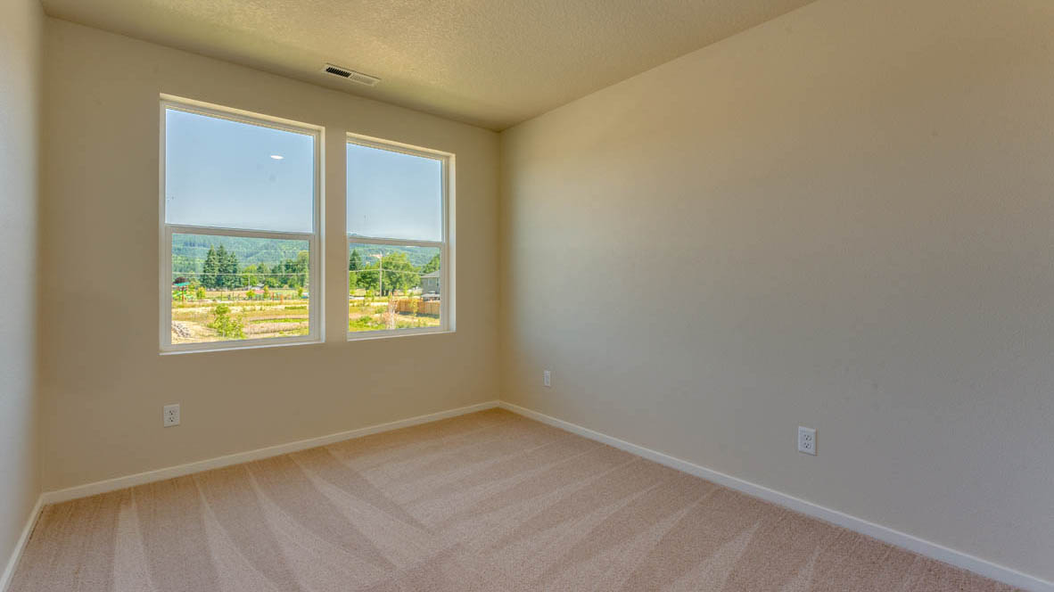 Marcola Meadows Bedroom with two windows and carpeting