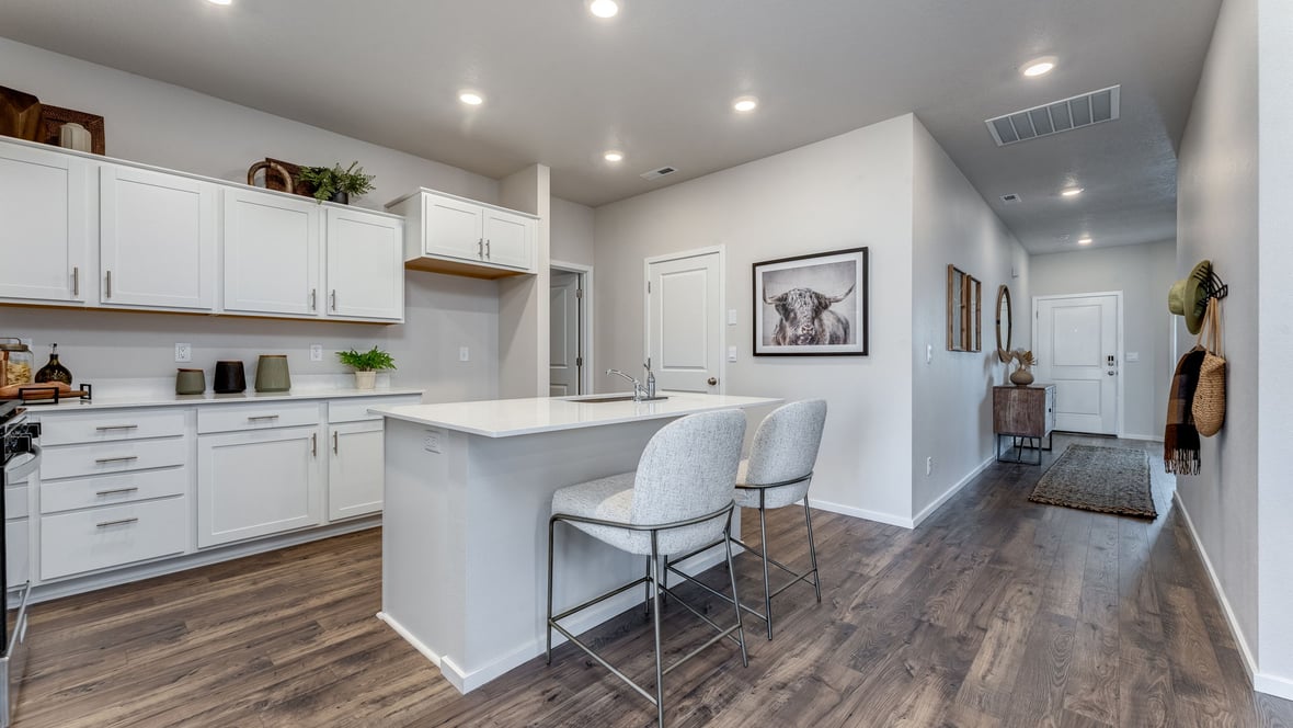 Marcola Meadows Kitchen with white cabinet, quartz countertops, and an island