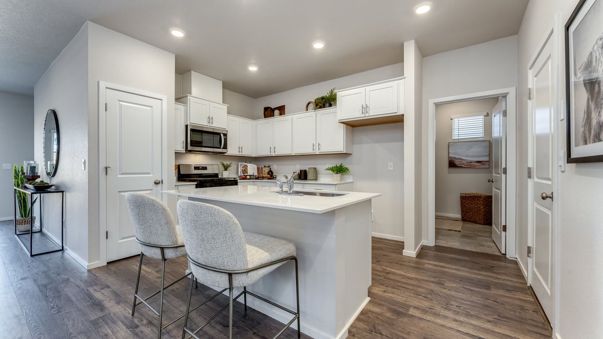 Marcola Meadows Kitchen with white cabinet, quartz countertops, and an island