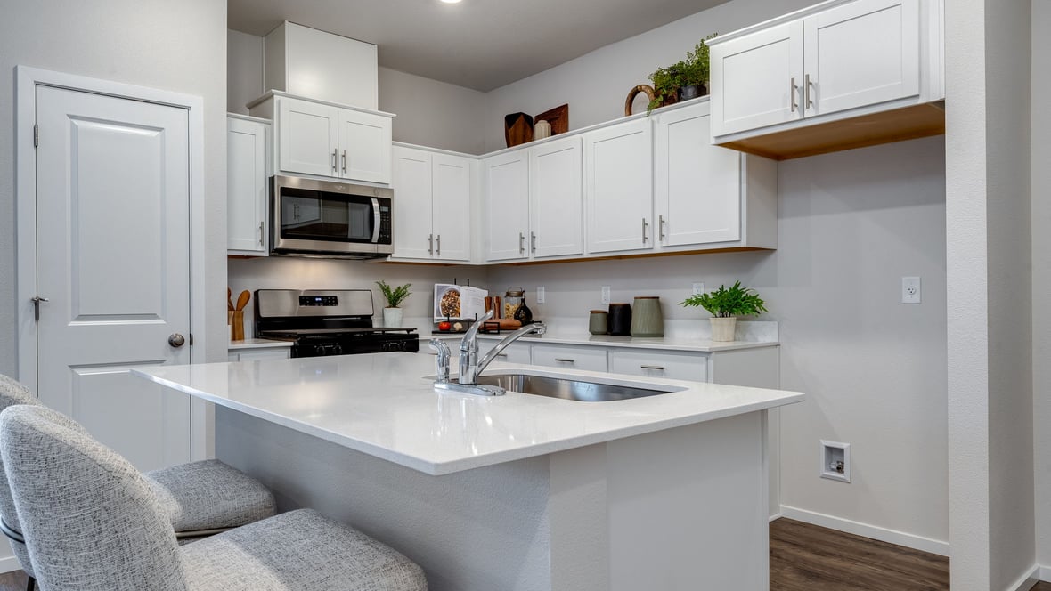 Marcola Meadows Kitchen with white cabinet, quartz countertops, and an island