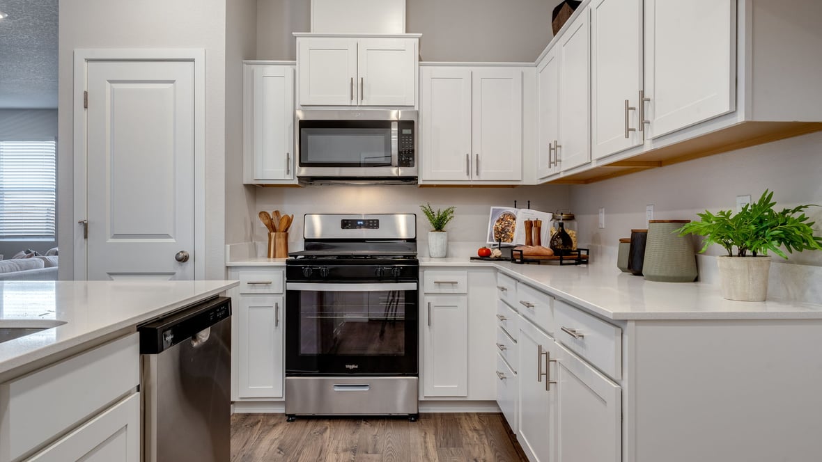 Marcola Meadows Kitchen with white cabinet, quartz countertops, and an island