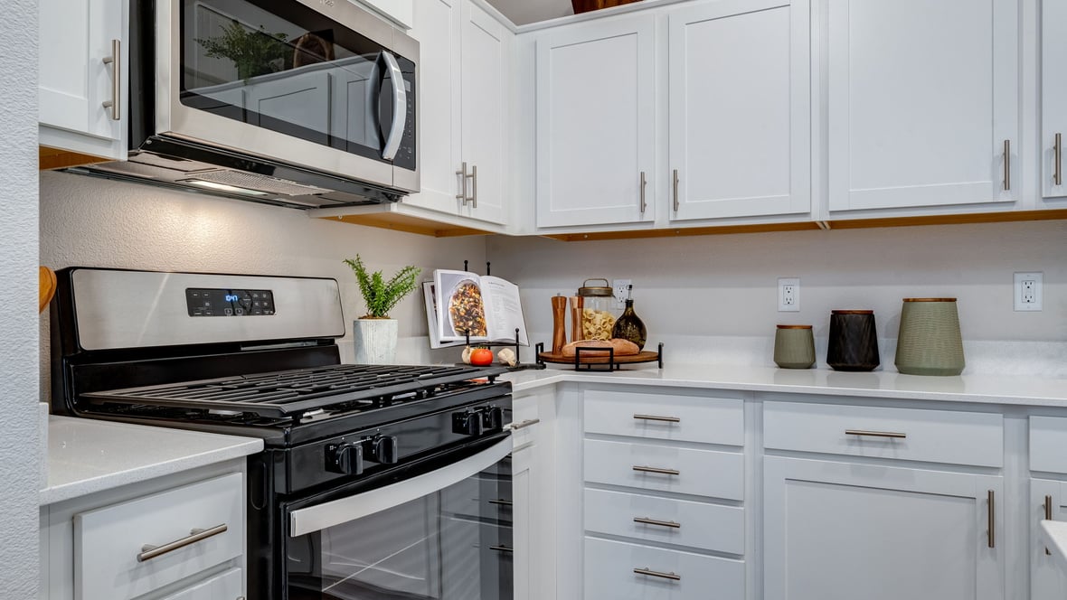 Marcola Meadows Kitchen with white cabinet, quartz countertops, and an island