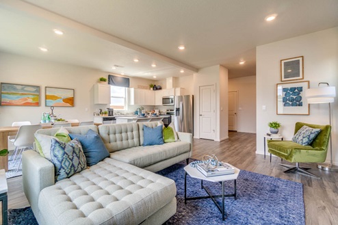 Marcola Meadows White couch in the great room and kitchen with white cabinets