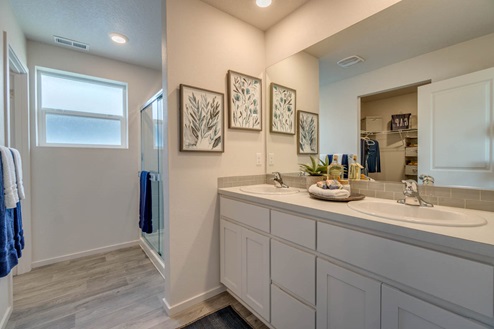 Marcola Meadows Bathroom that includes double sinks vanity with white cabinet and countertops right next to the standing shower