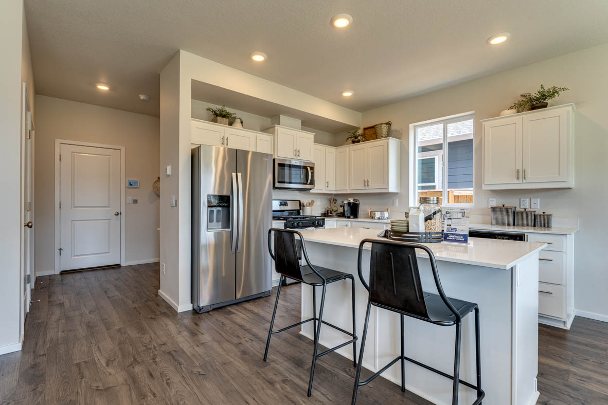 Marcola Meadows Kitchen with white cabinet, an island, stainless steel kitchen appliances
