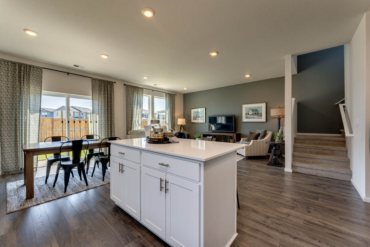 Marcola Meadows Kitchen with white cabinet, an island, stainless steel kitchen appliances, and dining room and patio door in the back