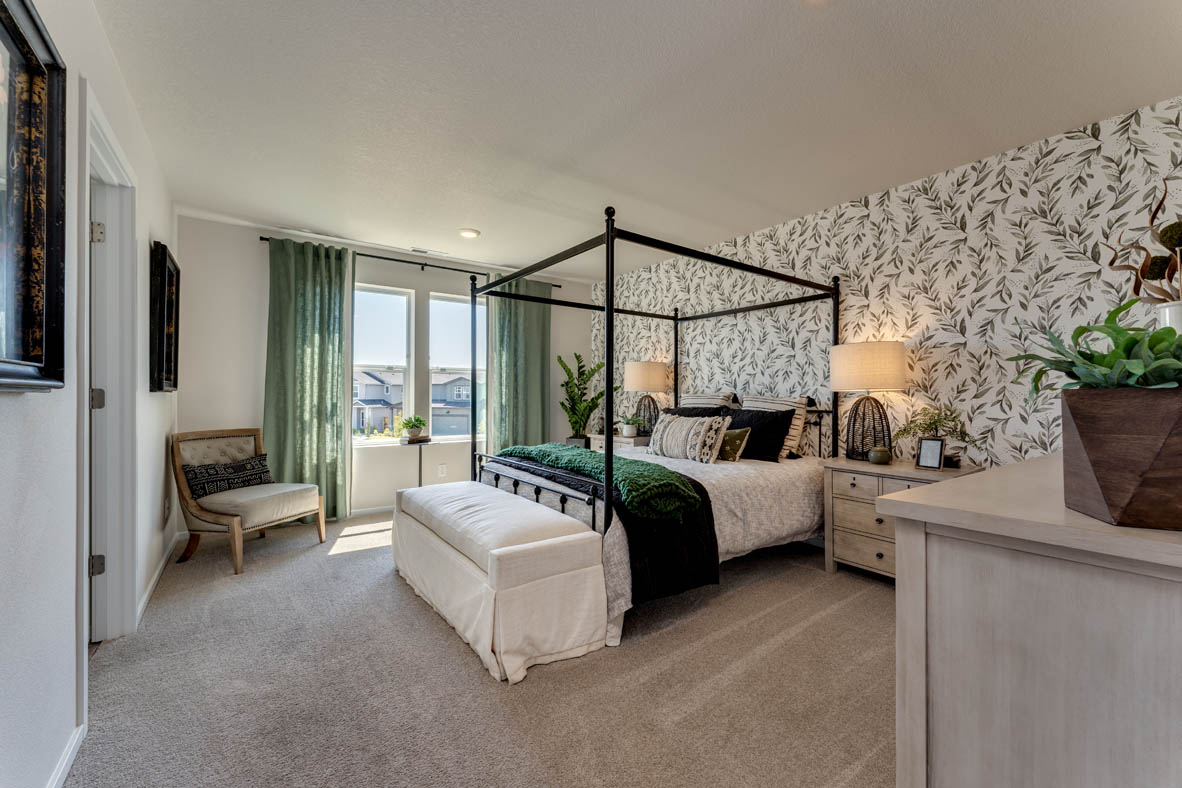 Marcola Meadows Bedroom with a king size bed and a green leafy accent wall and two windows