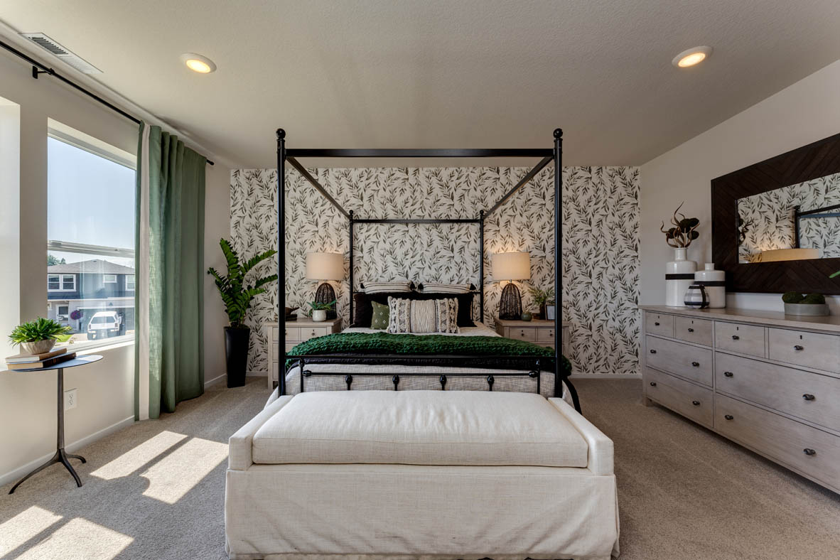 Marcola Meadows Bedroom with a king size bed and a green leafy accent wall and two windows