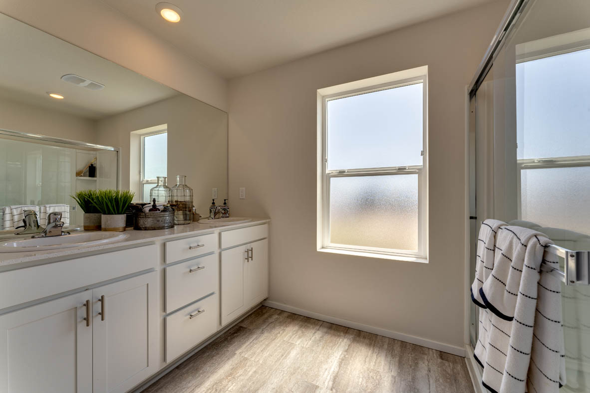 Marcola Meadows Bathroom that includes double sinks vanity with white cabinet and countertops right next to a privacy window