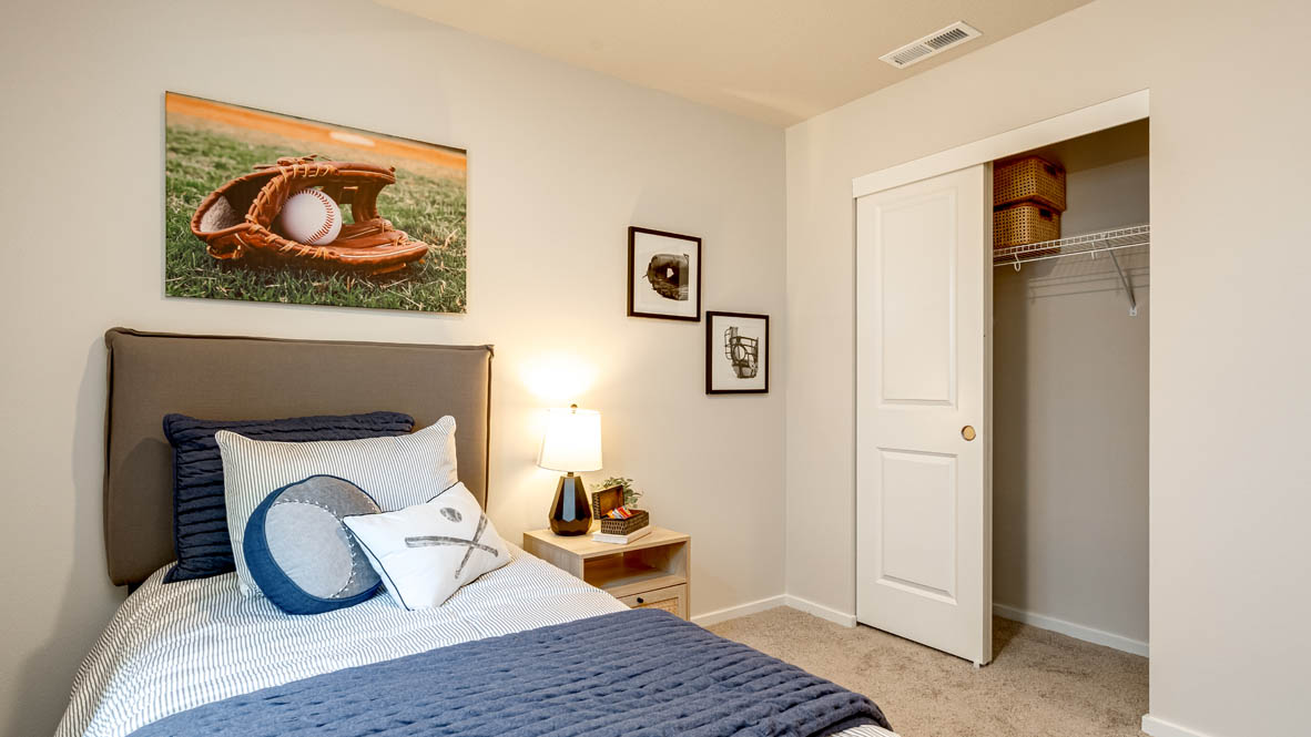 Eden Estates bedroom with carpet, window, and white walls