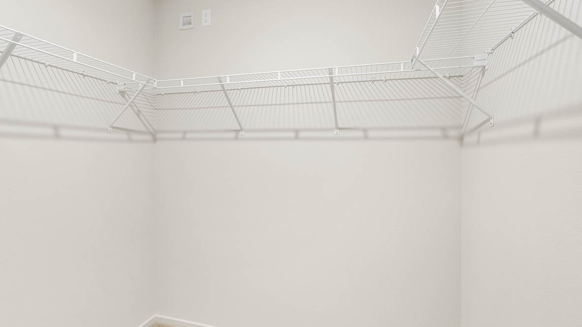 Eden Estates walk in closet with white wire shelving