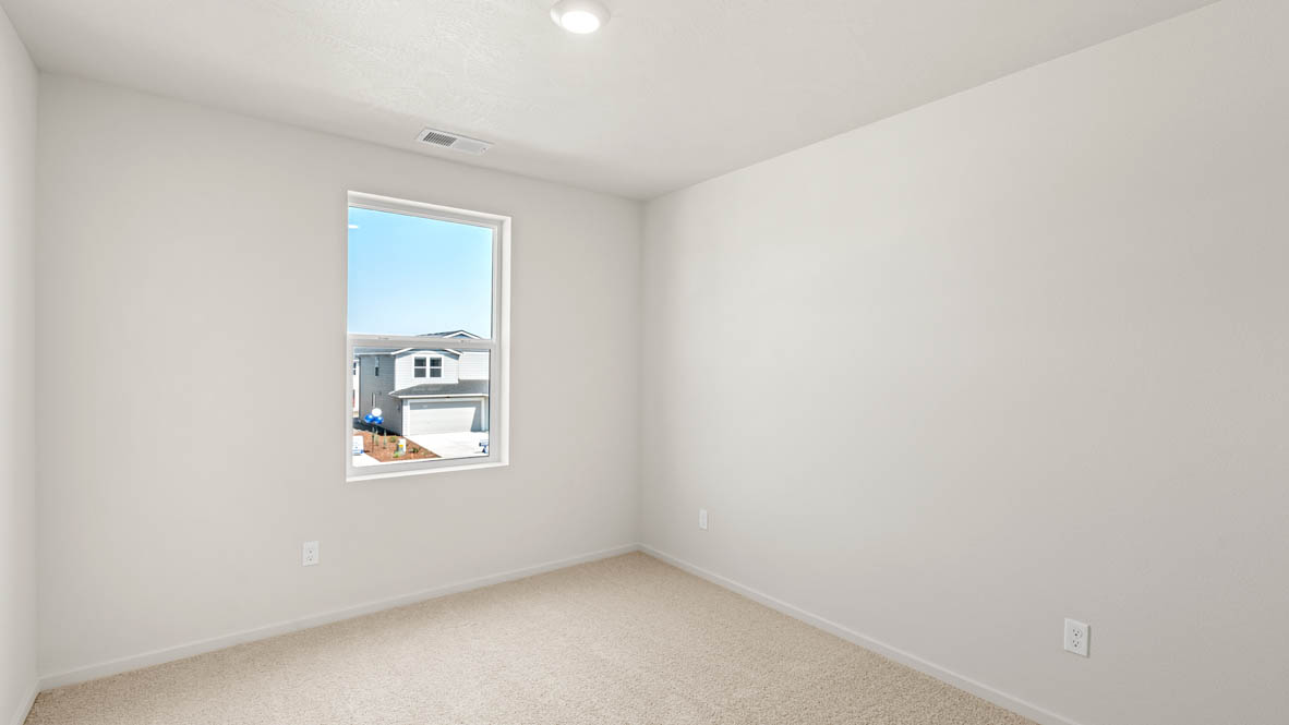 Eden Estates bedroom with carpet, window, and white walls