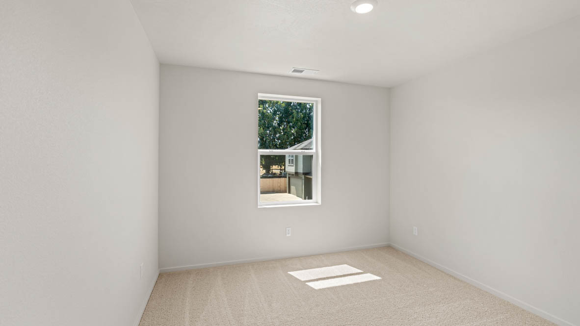 Eden Estates bedroom with carpet, window, and white walls