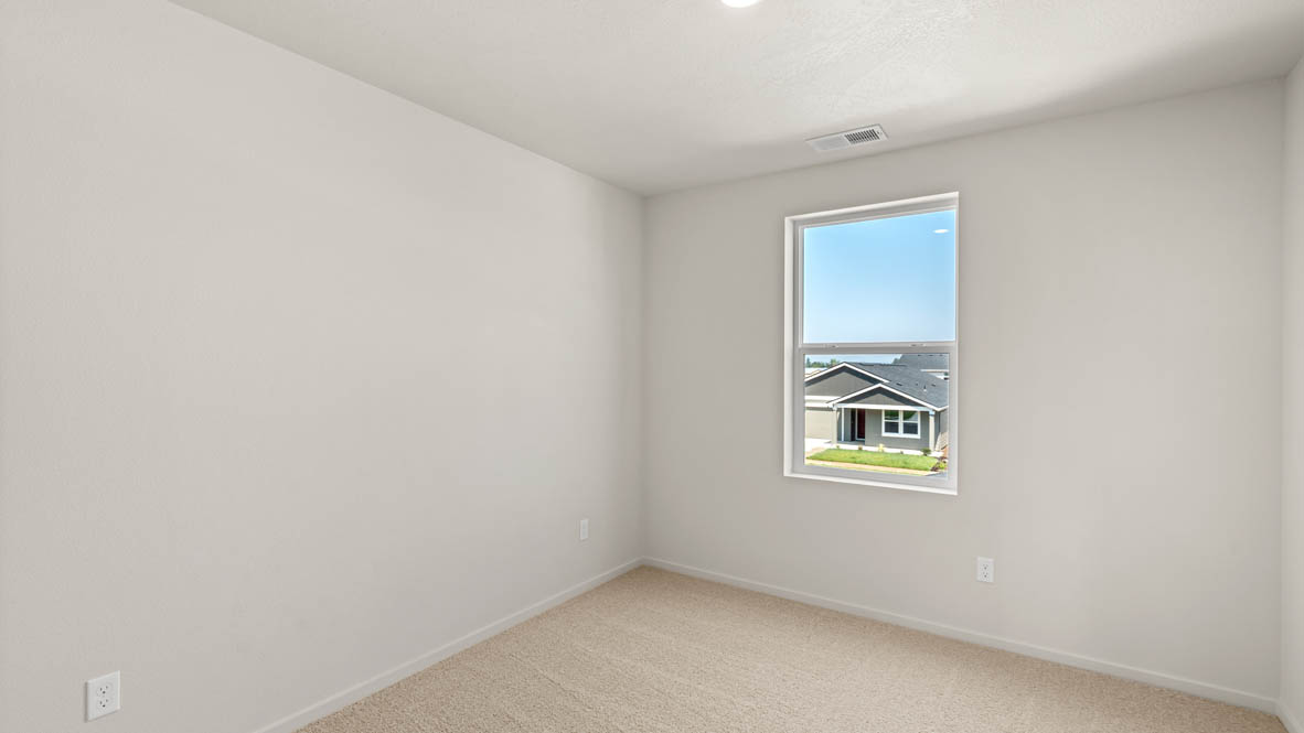 Eden Estates bedroom with carpet, window, and white walls
