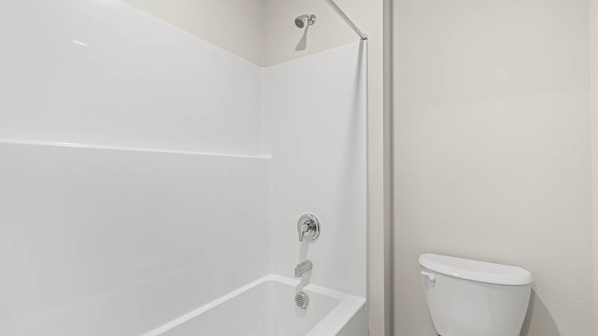 Eden estates bathroom with solid surface countertops, mirror, and cabinets