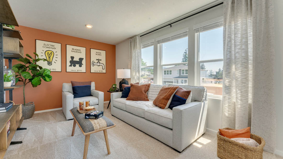 Eden estates bonus bedroom with two paintings, coffee table, white carpet, couch with pillows, hanging shelves, two chairs, a lamp, and windows with curtains
