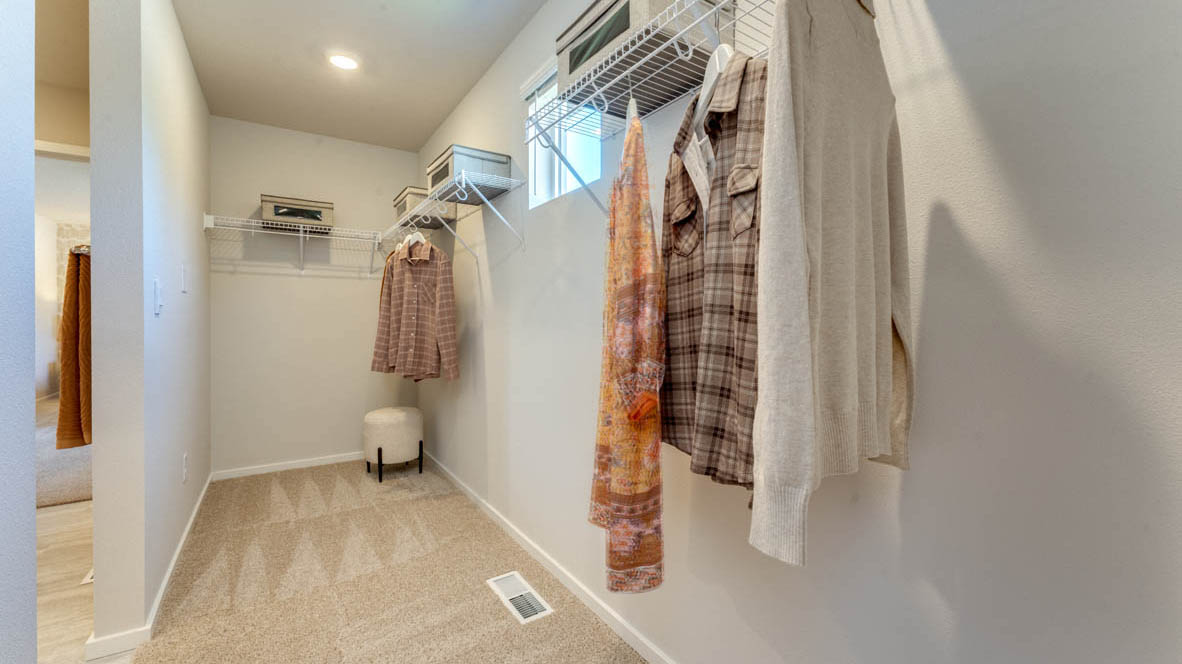 Eden Estates walk-in closet with white wire hangers