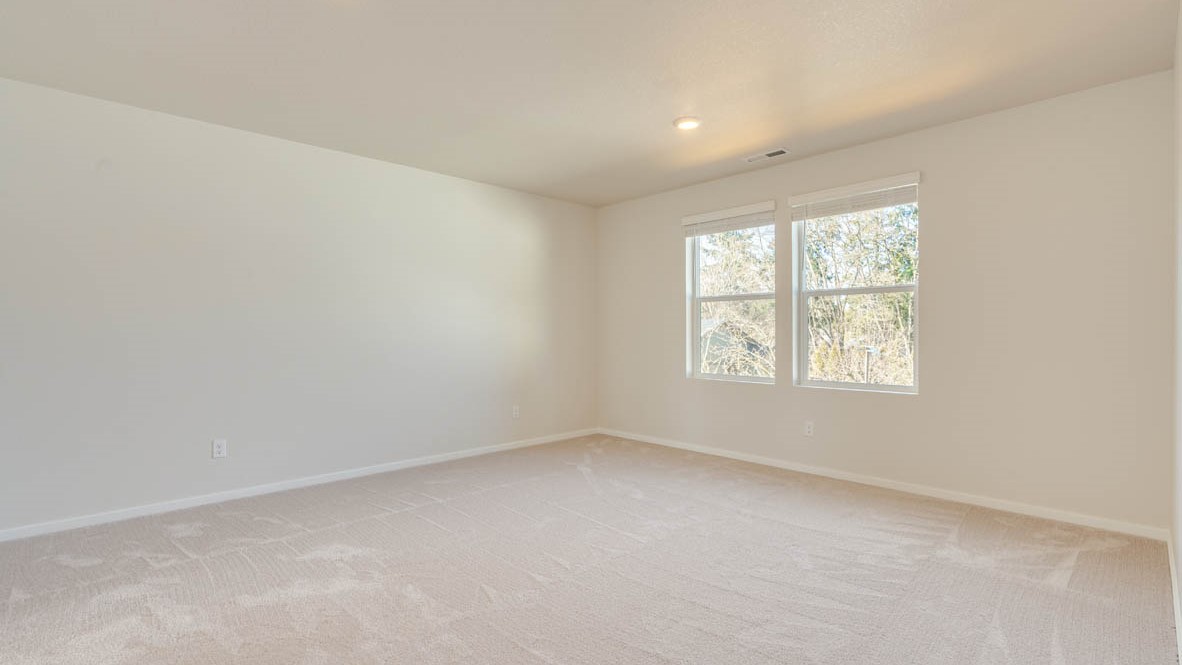 Eden Estates bedroom with carpet, window, and white walls