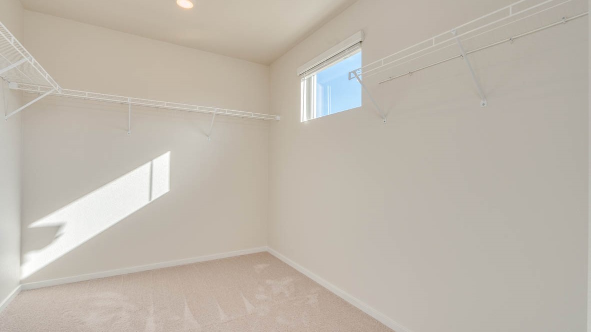 Eden Estates walk in closet with white wire shelving