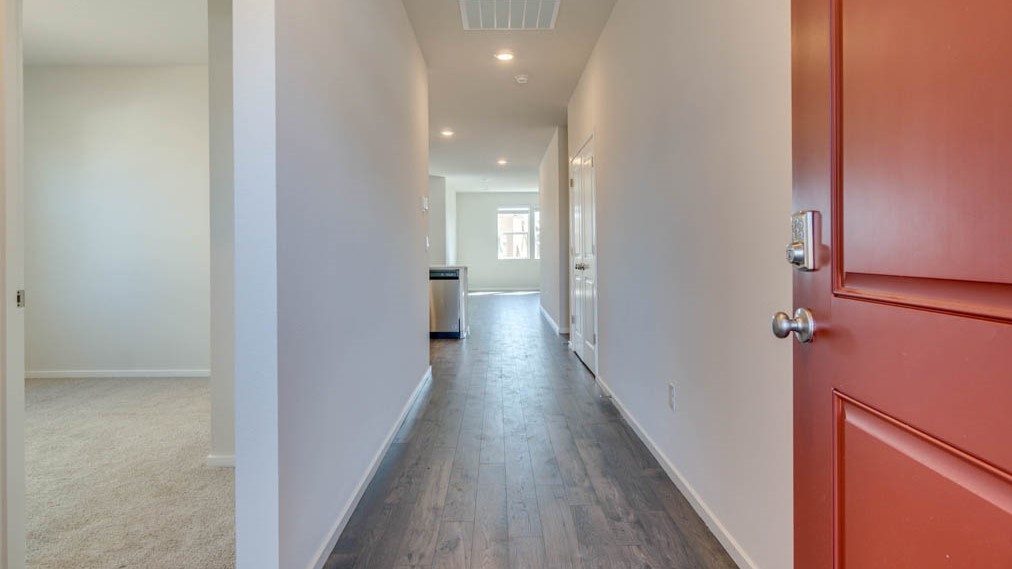 Eden Estates Entry with carpeted stairs, laminate flooring, and white walls