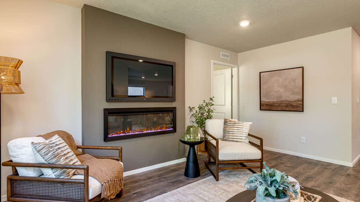 Eden Estates great room with fireplace, laminate flooring, and windows