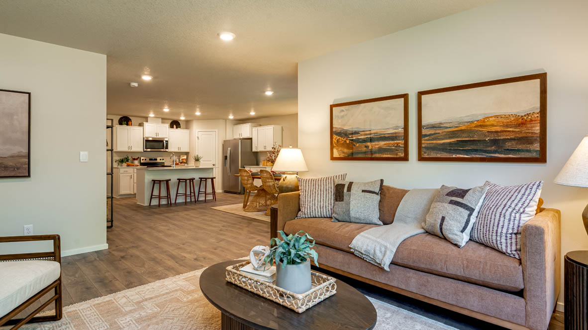 Eden Estates great room with fireplace, laminate flooring, and windows