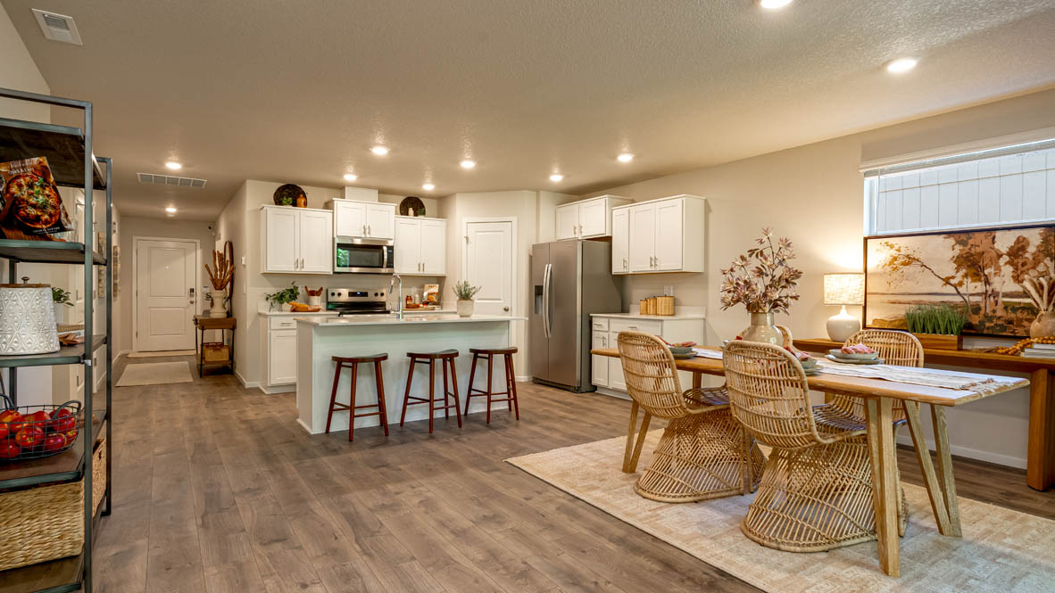 Eden Estates great room with fireplace, laminate flooring, and windows