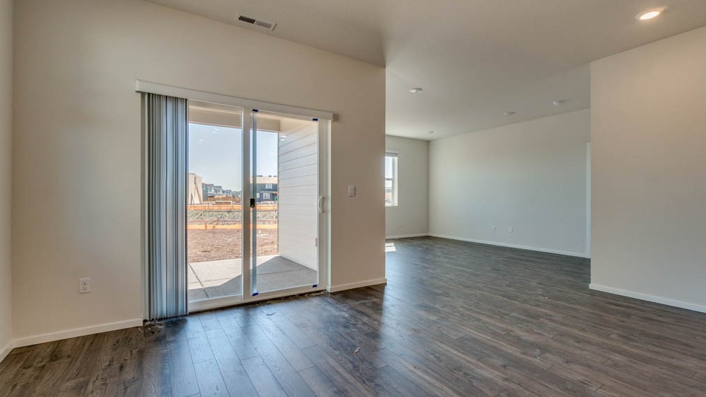 Eden Estates kitchen with laminate flooring, stainless steel appliances, cabinets, window, solid surface countertops