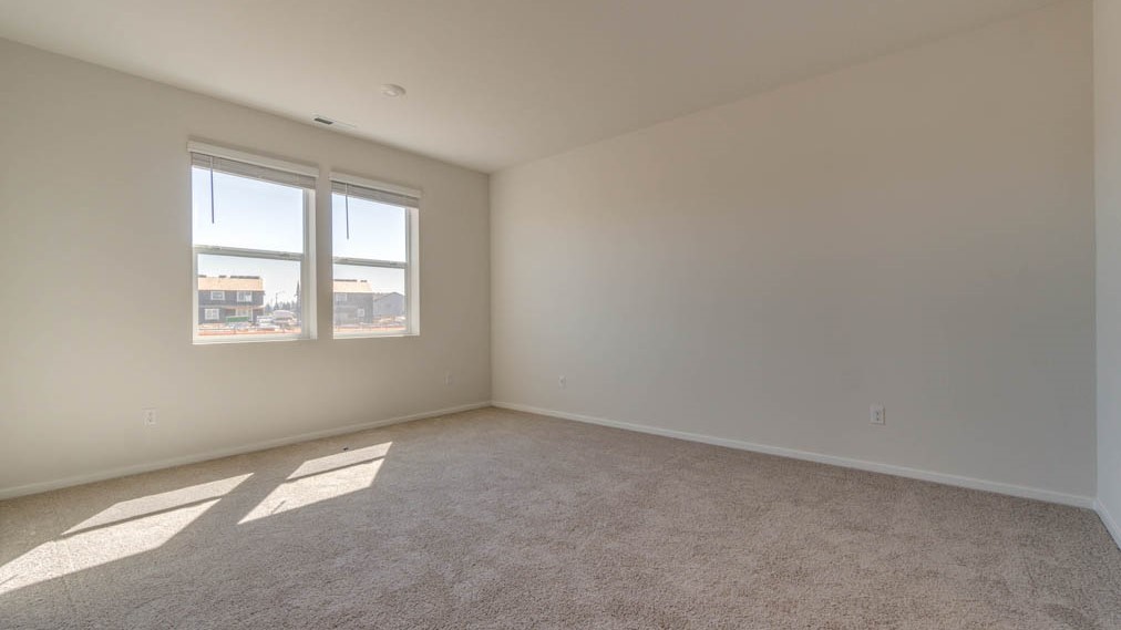 Eden Estates bedroom with carpet, window, and white walls