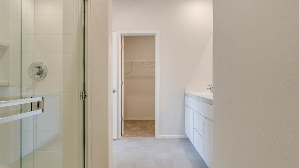 Eden Estates bathroom with toilet, and white shower tub