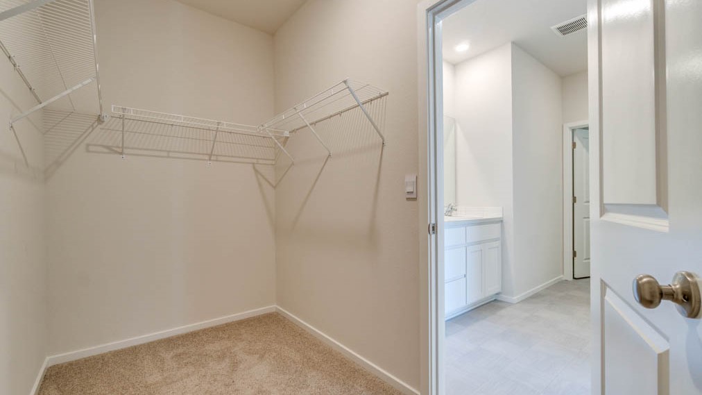 Eden Estates walk in closet with white wire shelving