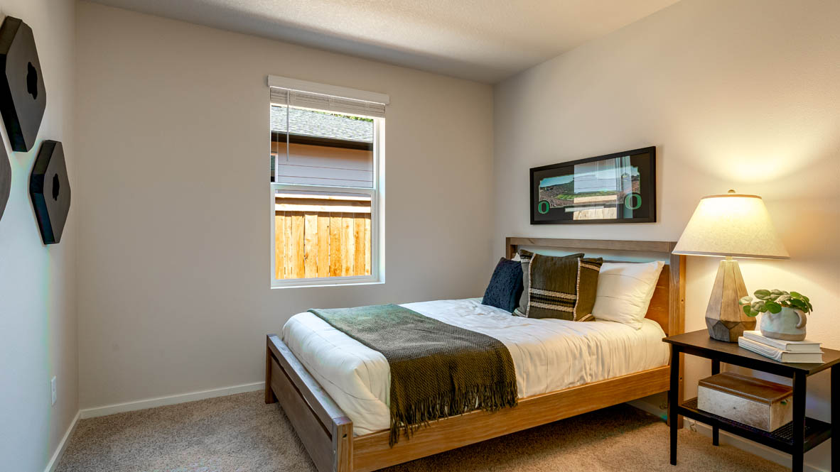 Eden Estates bedroom with carpet, window, and white walls