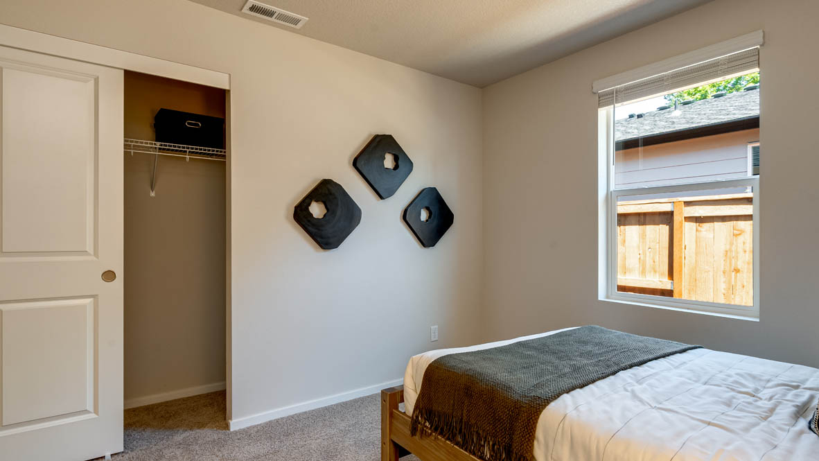 Eden Estates bedroom with carpet, window, and white walls