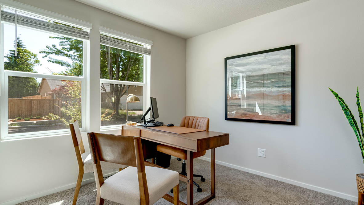 Eden Estates office with desk, chair, painting, and window