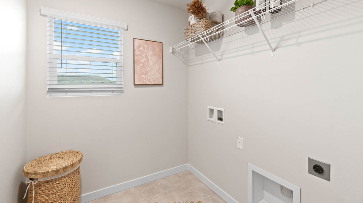 Sorrento Estates Laundry room with white wire shelving and hamper