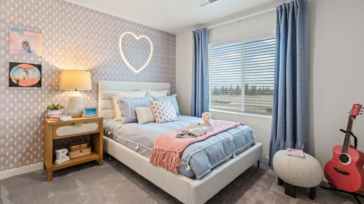 Sorrento Estates Bedroom with heart and music theme, a pink and blue bed, a pink guitar and pink drapes