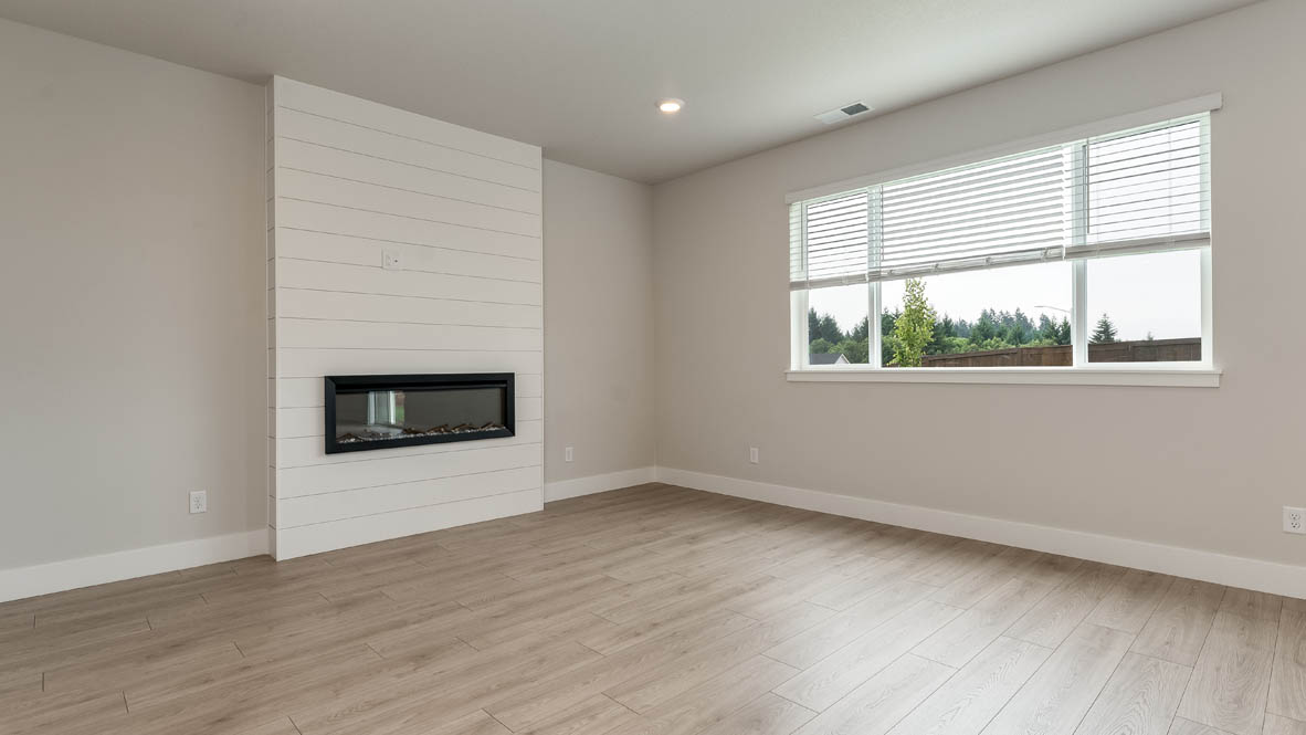 Sorrento Estates great room with shiplap wall and electric fireplace