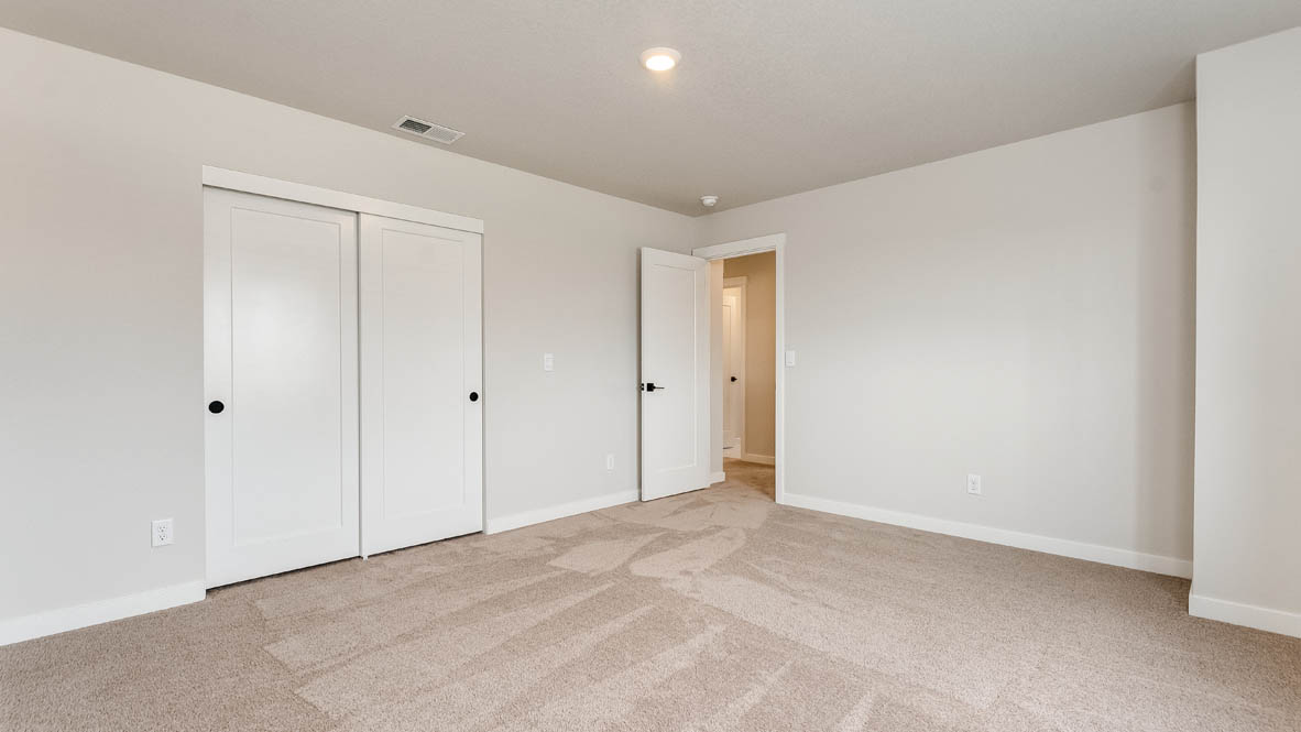 Sorrento Estates bedroom with carpeting and white walls