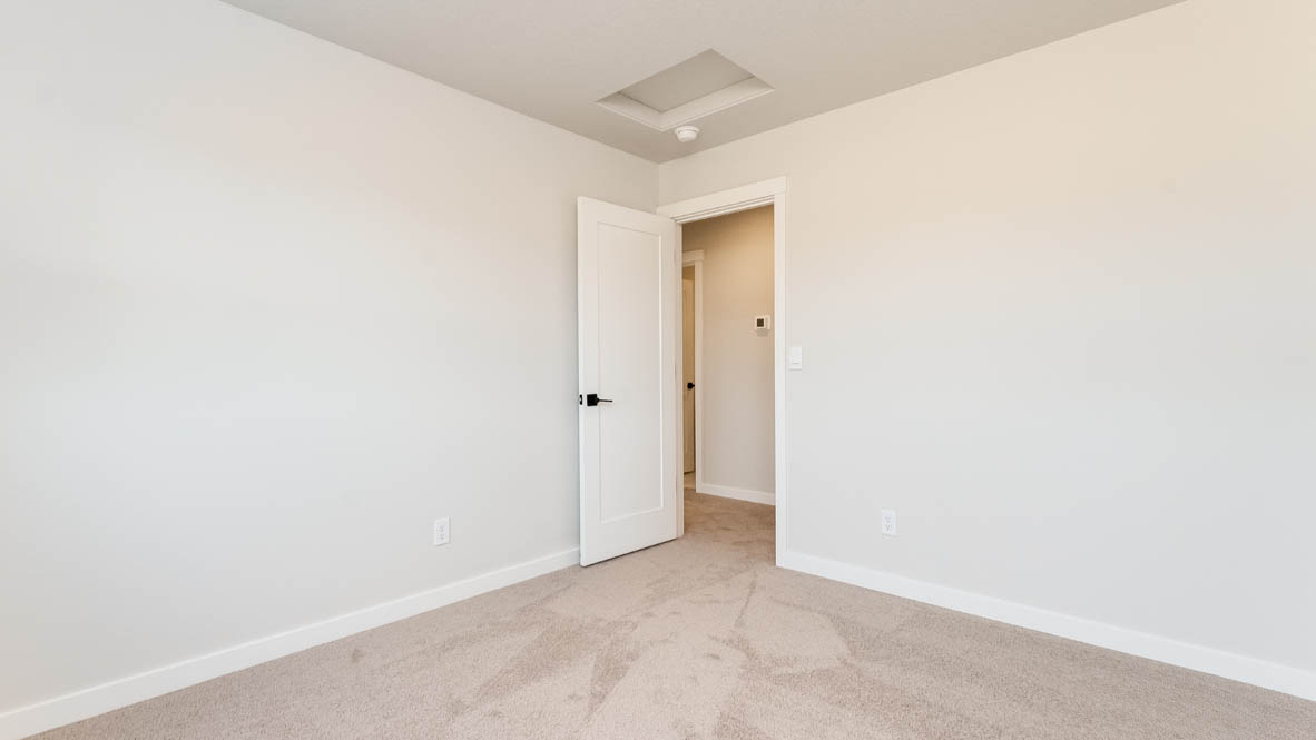 Sorrento Estates bedroom with windows and carpeting and white walls