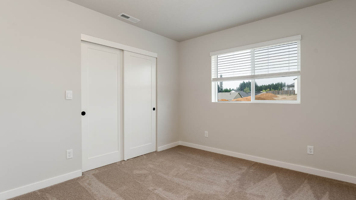Sorrento Estates bedroom with windows and carpeting and white walls