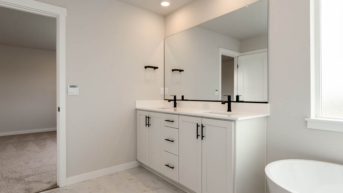Sorrento Estates primary bathroom with free standing tub and walk in shower and walk in closet and double sink vanity