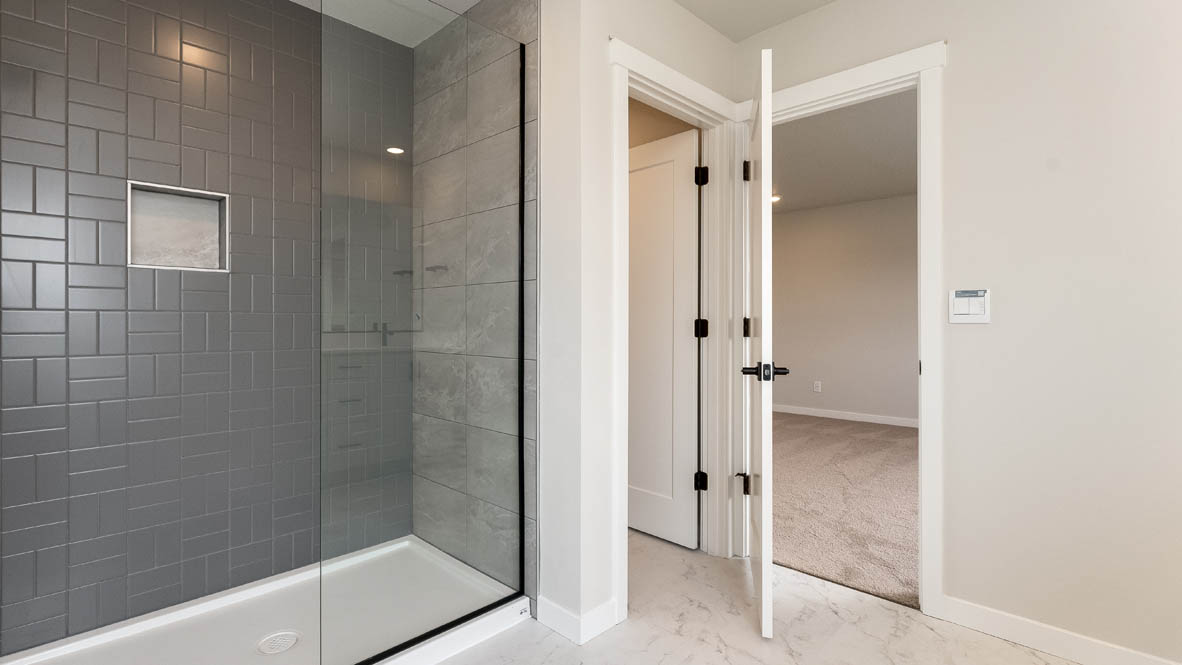 Sorrento Estates primary bathroom with free standing tub and walk in shower and walk in closet and double sink vanity